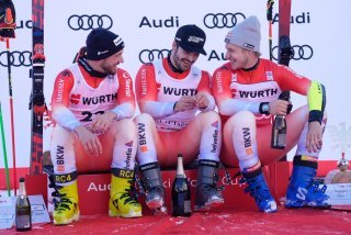 Loïc Meillard, au centre, entouré par ses coéquipiers, Luca Aerni et Marco Odermatt (droite).