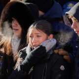 Mourners cry as they attend a memorial march in Crans-Montana, Swiss Alps, Switzerland, Sunday, Jan. 4, 2026, after a devastating fire in Le Constellation bar left dead and injured during the New Year's celebrations. (AP Photo/Baz Ratner)