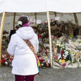 KEYPIX - Flowers and candles are pictured in tribute to the victims after the fire at the