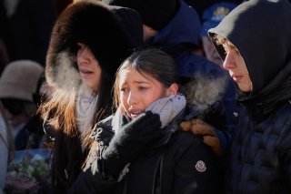 Mourners cry as they attend a memorial march in Crans-Montana, Swiss Alps, Switzerland, Sunday, Jan. 4, 2026, after a devastating fire in Le Constellation bar left dead and injured during the New Year's celebrations. (AP Photo/Baz Ratner)
